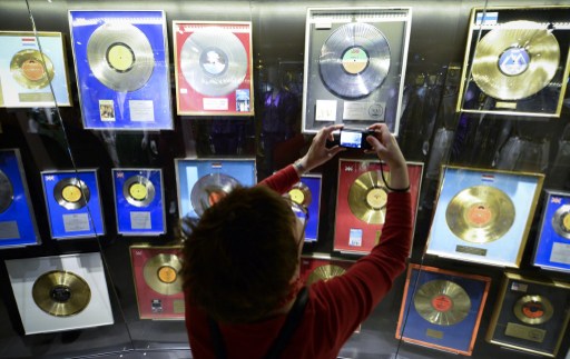 A visitor takes a photo of golden records of Swedish disco band ABBA on May 7, 2013 in Stockholm in the Gold Room at worldu00e2u20acu2122s first permanent ABBA museum. u00e2u20acu201d AFP pic