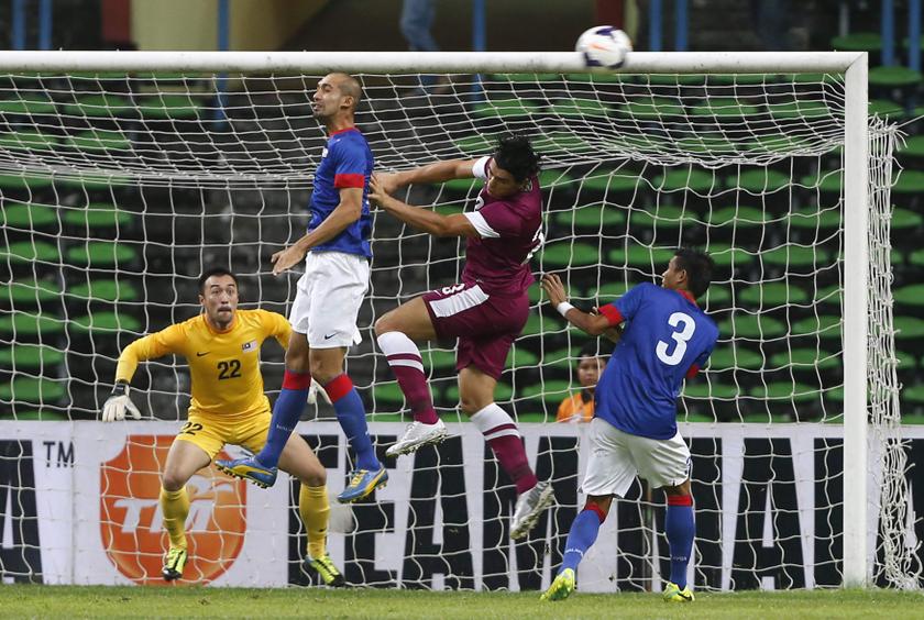 Malaysia's Amirizwan Taj (2nd left) fights for the ball with Qatar's Abdel Karim (2nd right) during the AFC Asian Cup 2015 qualifier soccer match in Shah Alam outside Kuala Lumpur November 19, 2013. u00e2u20acu201d Reuters pic