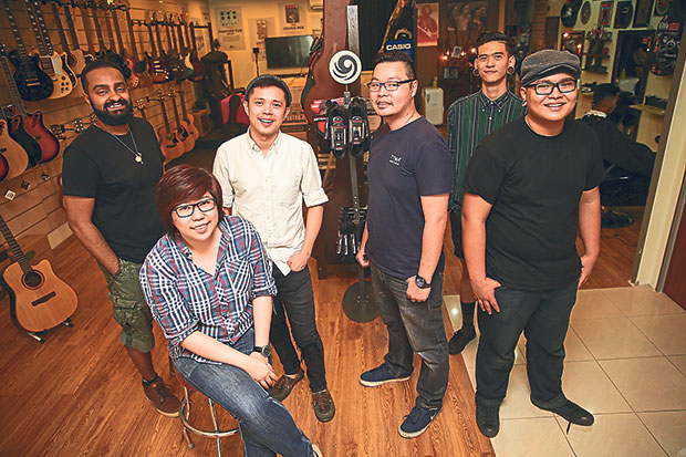 The entire staff from Amplitude, from left: Kishen Dave, sales representative; Yune Ine, academy director (seated); chief barber Lex Low; music store director Jon Lim; barbers Bryan Low and Kevin Tan