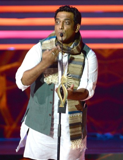 Indian Bollywood director Anurag Basu enacts a character from his film “Barfi” after winning the award for Best Film. — AFP pic