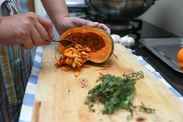 Deseeding a pumpkin is part of their prep work. – Picture by Saw Siow Feng