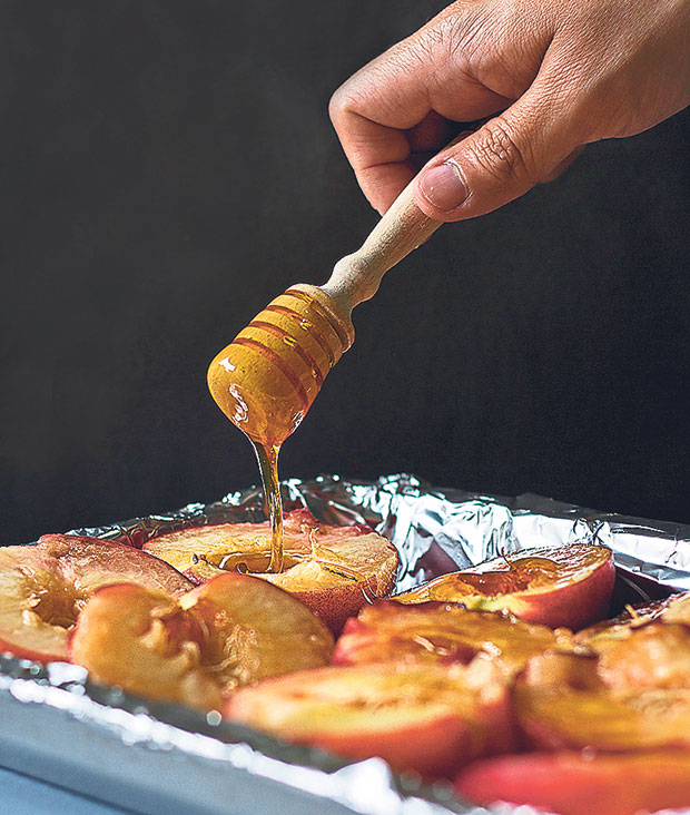 Drizzle organic honey over the peaches, making sure every half receives some
