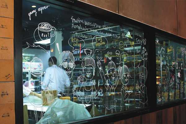 Behind caricatures of coffee lovers lies the central kitchen for both Roots and Roast.