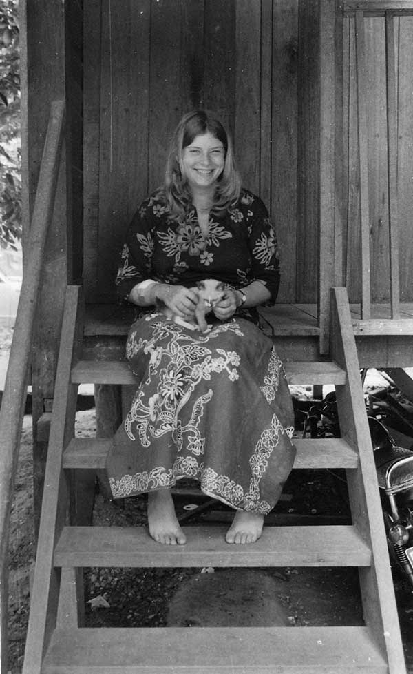 Barbara Ismail sitting on the steps of her Kampong Dusun house, having recently arrived in Kelantan in 1977