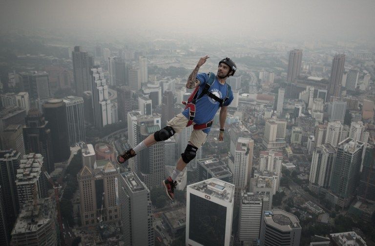 Base jumper Theo Gagliardini from France leaps from the 300-metres Open Deck of the Malaysiau00e2u20acu2122s landmark Kuala Lumpur Tower during the International Tower Jump in Kuala Lumpur on September 28, 2013. u00e2u20acu201d AFP pic