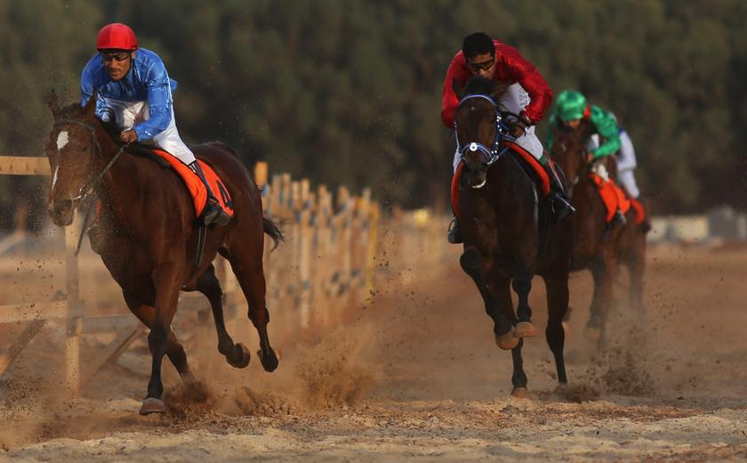 Emad Al Salami (left), riding Al Hoda, competes in the 1,600-metres Championship qualifiers during an annual horse racing tournament held by locals in Benghazi, December 14, 2013. u00e2u20acu201d Reuters pic