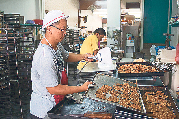 Workers preparing the pepper biscuits at the small bakery at the back portion of the shophouse