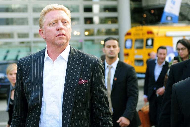 Former tennis player Boris Becker (left) walks through the fair hall after the presentation of his biography 'Life is no game' at the Frankfurt Book Fair 2013 in Frankfurt, on October 10, 2013. u00e2u20acu201d AFP pic