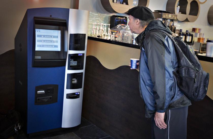 A man looks at the world's first ever permanent bitcoin ATM unveiled at a coffee shop in Vancouver, British Columbia October 29, 2013.u00e2u20acu201d Reuters pic
