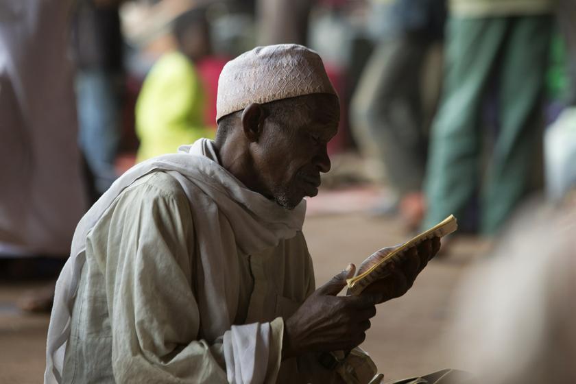 A man prays while reading verses from the Quran in a hangar at the airport of the capital Bangui. — Reuters pic