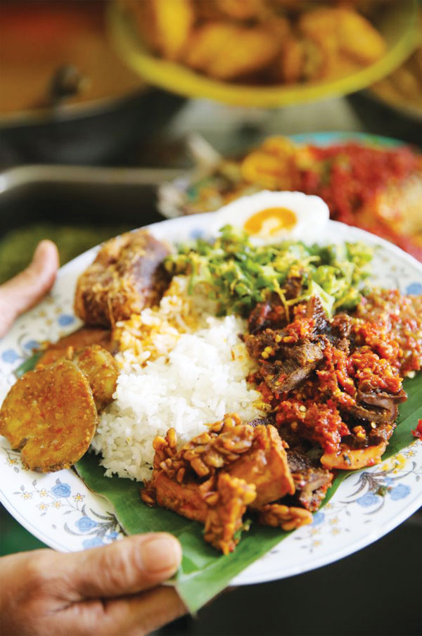 Our favourite Nasi Padang selection includes dendeng topped with sambal balado, fried tempe, bergedil, salted egg yolk, four angled beans kerabu and jering