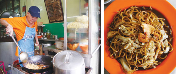 The friendly Uncle Teng or Ah Pek busy at his noodle stall. Next to him hangs the cafe’s old menu that dates back to 1956 (left). Old timers come here for the mee hailam that remind them of long forgotten days (right)