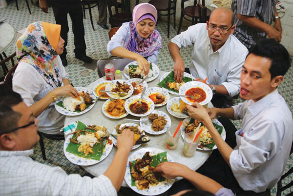 Diners enjoy a spread of Nasi Padang dishes
