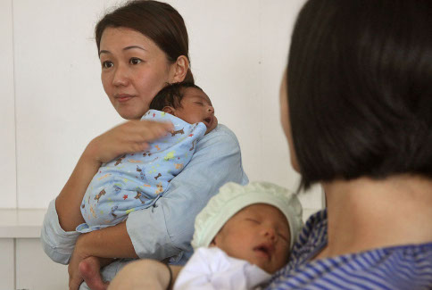 Gina Yongu00e2u20acu2122s business partner at Bonda Villa, Shirley Fan, holds a baby. Business is booming for confinement centres due to the Chinese practice of post-natal confinement involving new mothers.  u00e2u20acu201c Photo by Saw Siow Feng