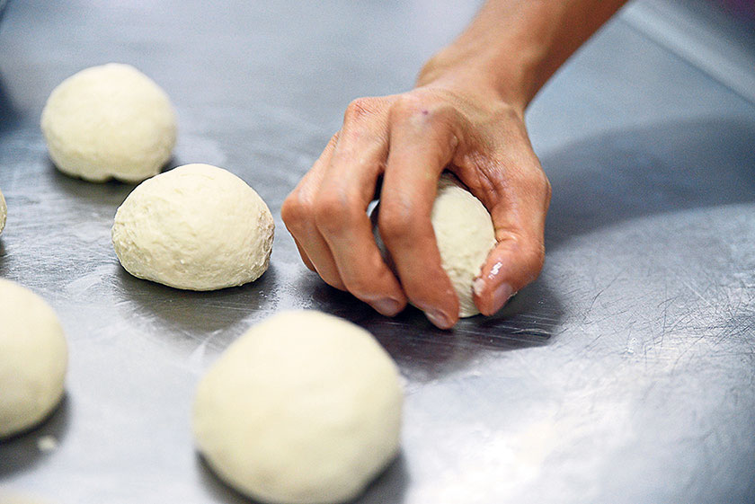 The fermented dough is shaped before it is baked