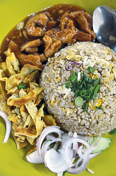 A delicious one-plate meal of fried rice and sides, perfect for individual diners, from a stall at Say Huat Restaurant