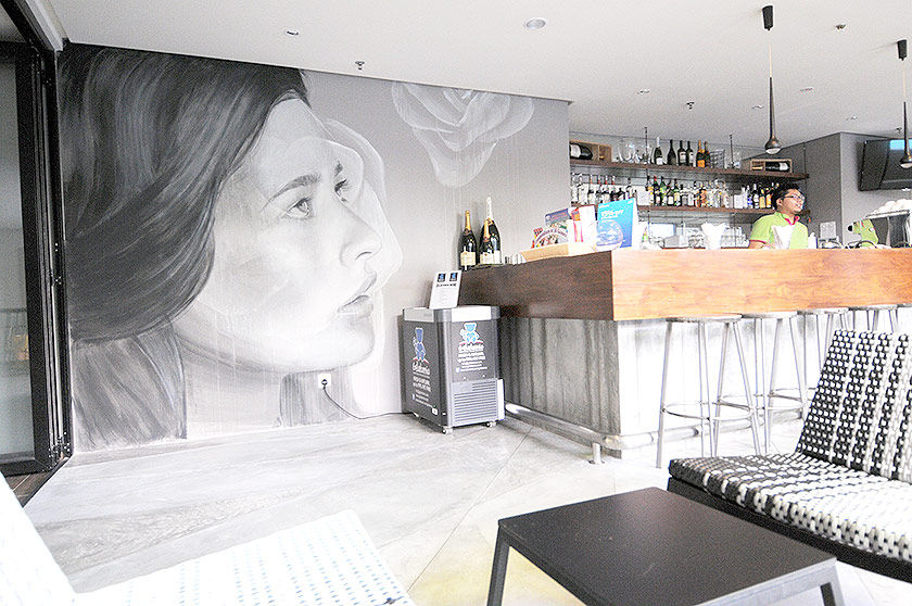 Another portrait by Rone at the coffee bar in Glow Hotel along Macalister Road as part of the Urban Exchange art festival