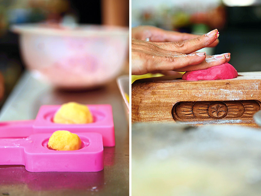 Mung bean paste shaped into balls are placed in the moulds to ensure they are the right size (left). The secret behind Debbie’s soft and slightly elastic kuih angku skin is the use of a softener known as 'ibu' made from a mixture of coconut milk, sugar, salt and glutinous rice flour. The skin is wrapped around the mung bean filling and pressed into the mould (right).