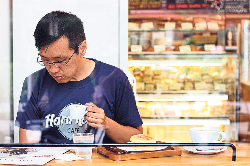 A customer at Jewel Coffee enjoying his coffee