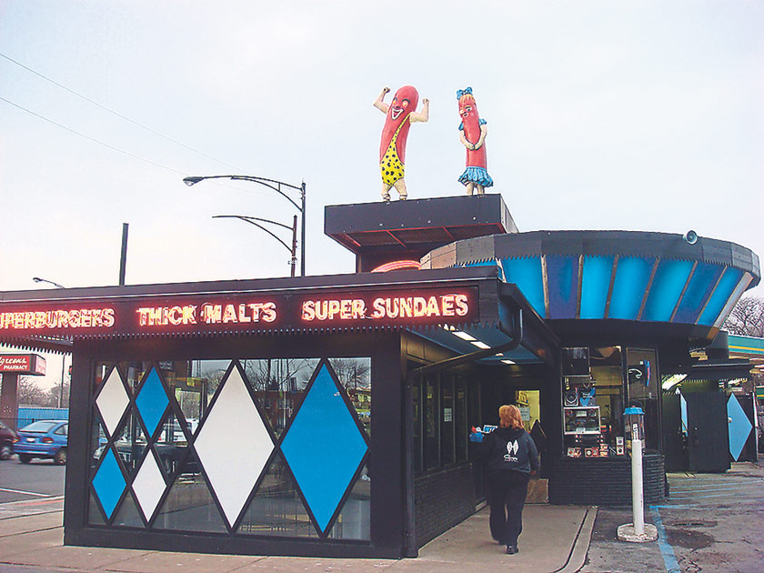 The original Superdawg drive-in restaurant, where their fun, flirty mascots still greet guests from the top of the building