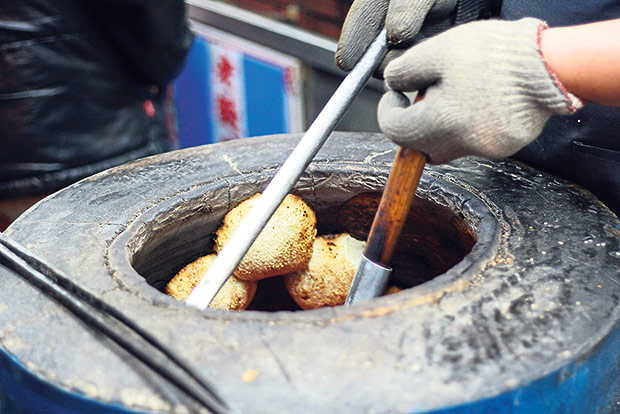 Pepper buns sticking by the sides of the oven as they bake.