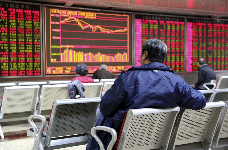 Investors sit in front of an electronic board showing stock information at a brokerage house in Beijing, China, November 16, 2015. u00e2u20acu201d Reuters picn