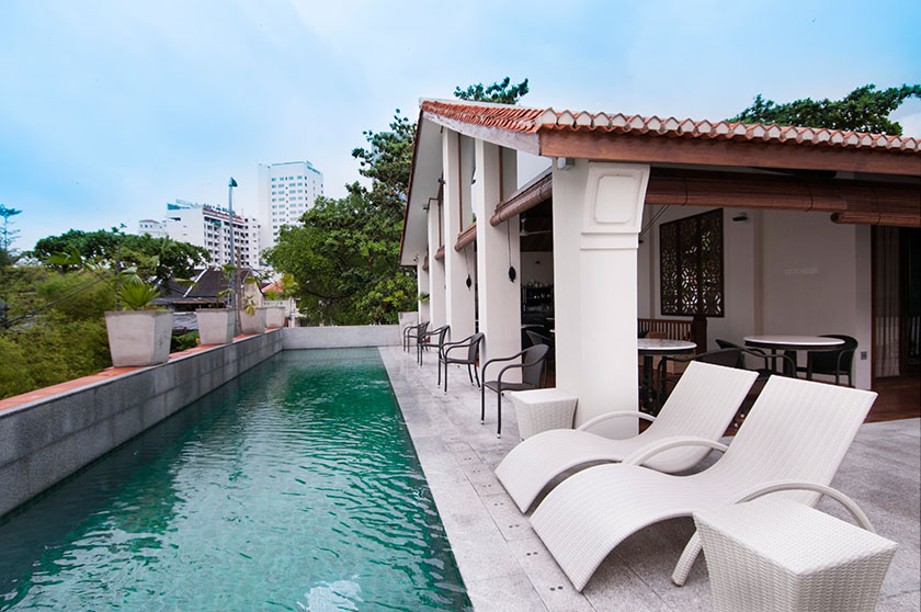 Guests get a view of the city at the poolside of Muntri Grove.