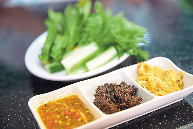 Pair a selection of ulam with their delicious homemade sambals (from left to right): mango belacan, sambal hitam and sambal tempoyak.