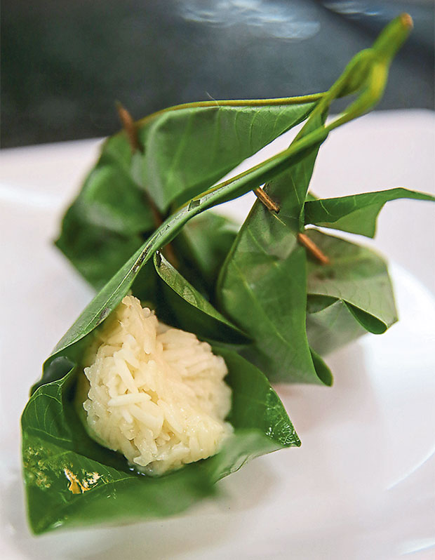 Look for this tapai pulut wrapped in fresh rubber leaves from the table.
