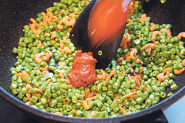Dried shrimps, long beans and chilli paste are essential toppings for Pangkor assam laksa.