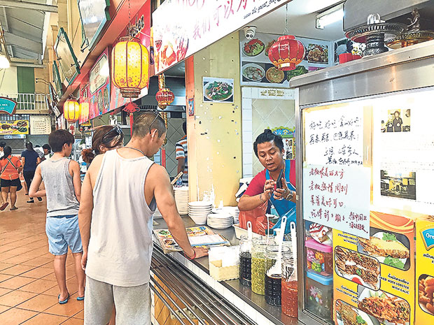 Customers haggling over prices at the food court at Banzaan Market.
