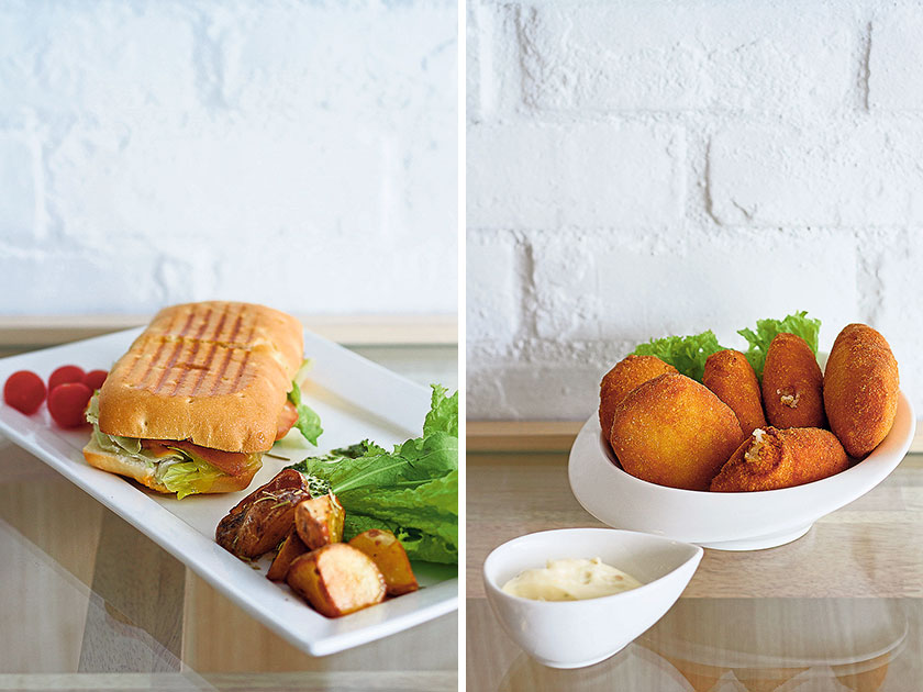 Atlas Signature Sandwich: a generously-sized panini of bacon, roast ham, tomato, lettuce, and mozzarella (left). Prawn croquettes are perfect for snacking or sharing (right)