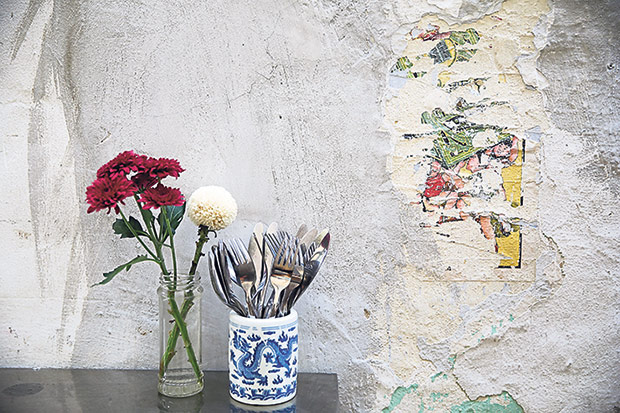 An old advertisement pasted on one of the walls, either for matchboxes or cigarettes.