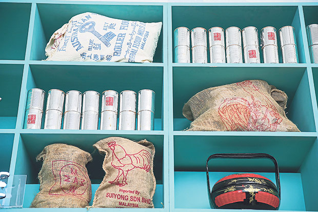 The teal-coloured shelves behind the bar with Merchant’s Lane trademark “chicken” gunny sacks.
