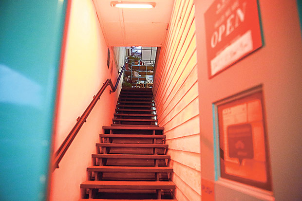 Red lights illuminate the staircase up to Merchant’s Lane.