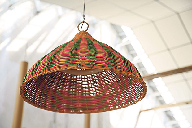 A traditional rattan food cover is transformed into a lamp.