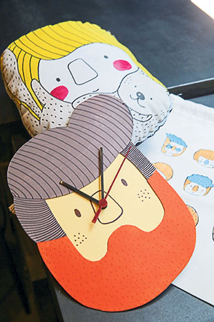 Hassan as a wall clock and Molly with her cat drawn on a plush toy.