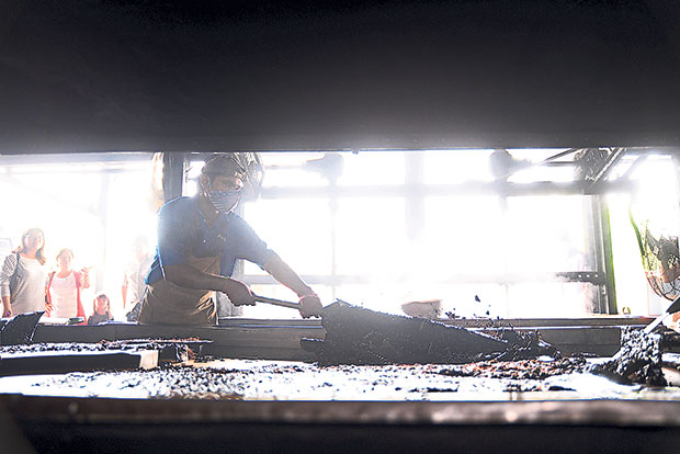 The cooked coffee and sugar mixture are laid out to dry before it is broken into smaller pieces.