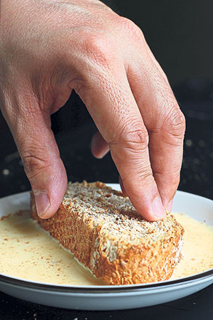 Soak the slices of bread in the egg-and-milk mixture.