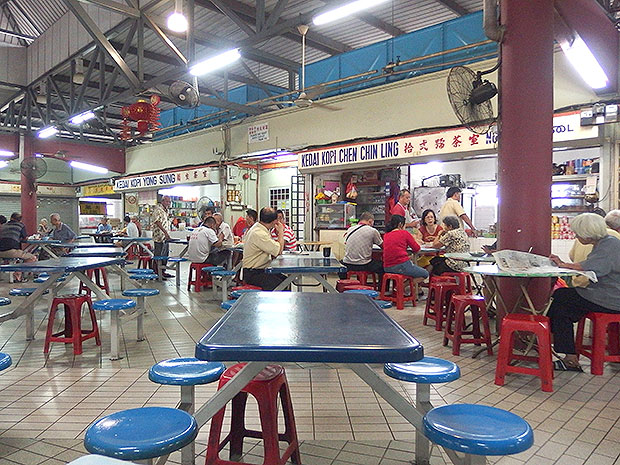 Spacious food court with high ceilings all the way on the third floor of the wet market building.