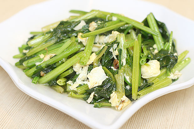 The simple yet satisfying spinach dish is stir fried with a soft fluffy omelette broken into pieces.