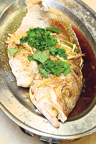 There’s a selection of fish with various sauces, like this steamed red snapper with soy sauce.