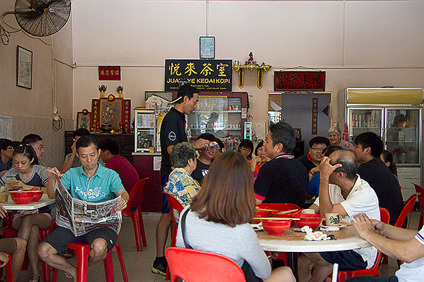 Regulars at Kedai Kopi Juat Lye happily tucking into their breakfast.