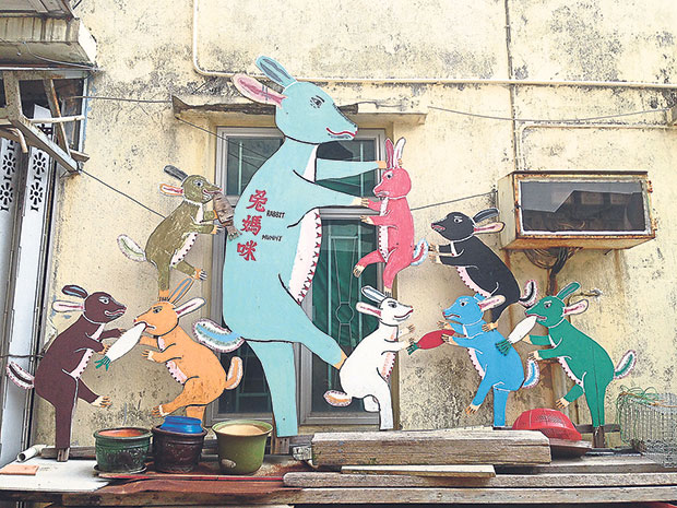 Kitschy street art dot a small alley