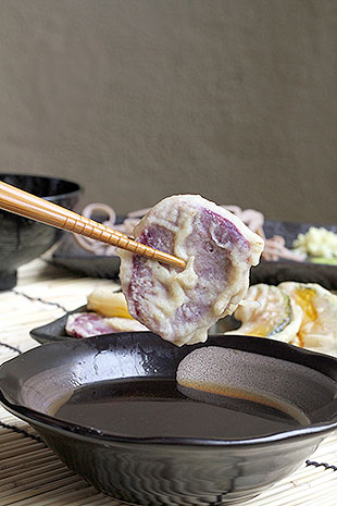 Dip the vegetable tempura lightly in the tentsuyu sauce