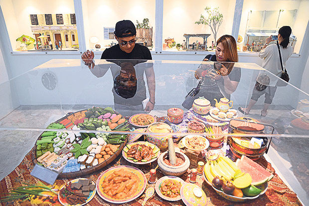 Visitors looking at the display of Nyonya food at the museum.