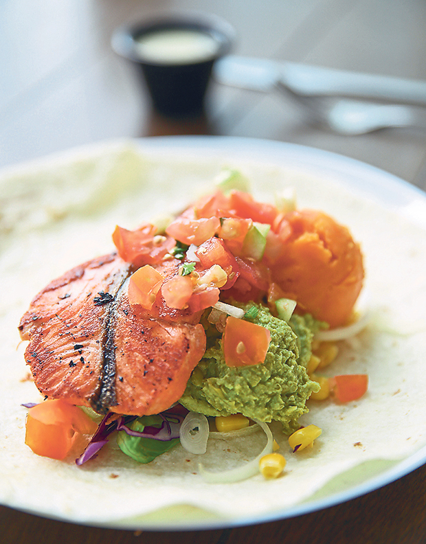 All their protein choices are freshly grilled upon order like this grilled salmon with mushy peas and sweet potato mash served as a wrap