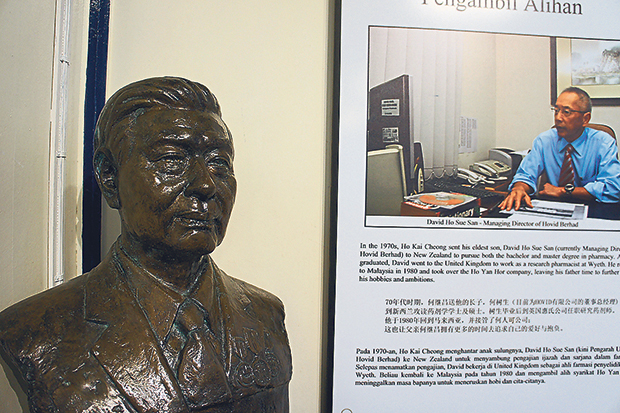 A bust of Ho Kai Cheong next to a display with a photo of his eldest son, David, who is now the Managing Director of the company