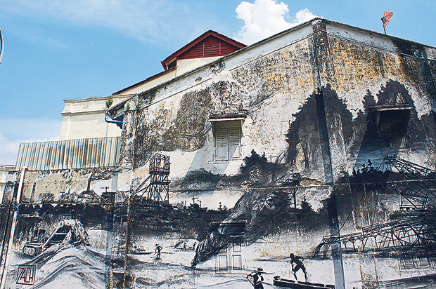 Ernest Zacharevic’s Evolution on the exterior wall of the museum