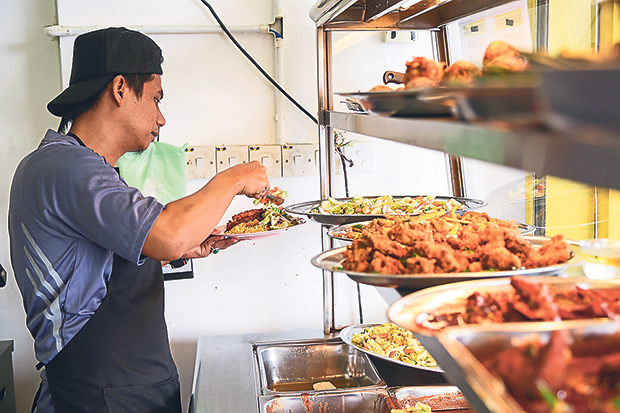 Once you place your order, they will laden up your plate of yellow rice with the goodies